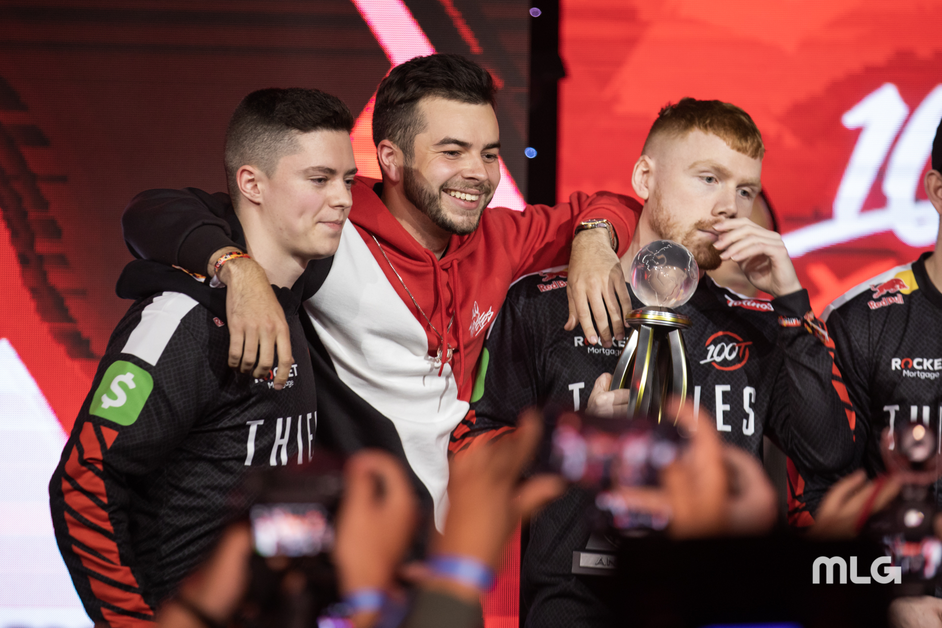 Nadeshot with his arms around CoD pros Enable and Priestahh after 100 Thieves won a CWL tournament.