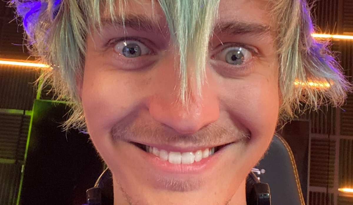 A close-up of Ninja grinning. He has green hair