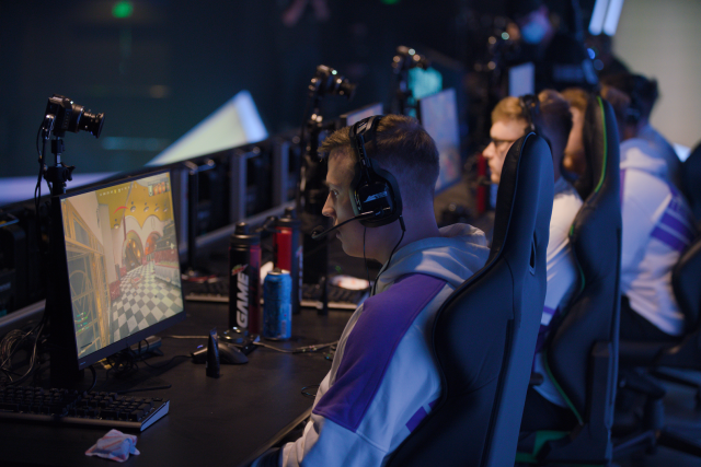 CleanX competing on-stage in the Call of Duty League with the Toronto Ultra, intensely looking at his monitor.