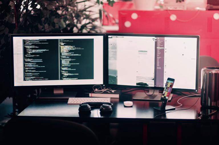 two computer monitors on a desk