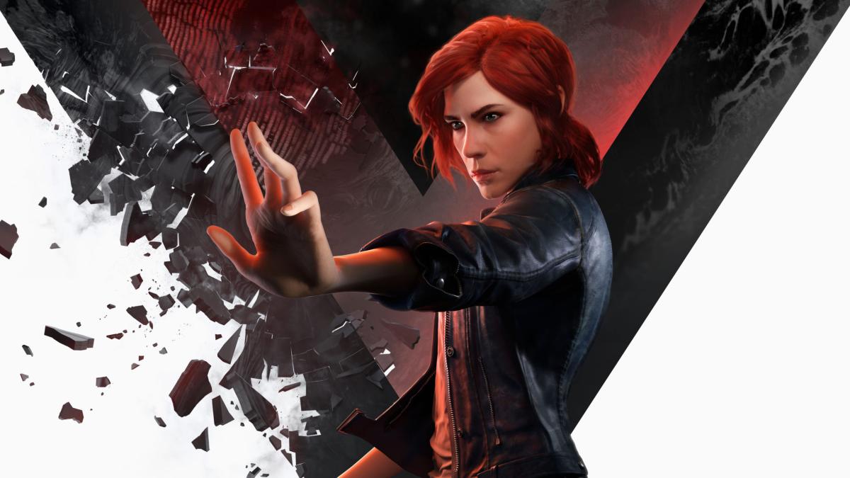 A red haired woman raises her hand, with broken pieces of stone floating around her.