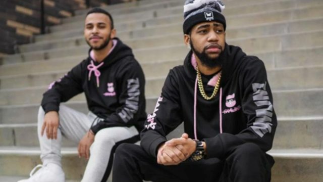 Hamlinz and Daequan sit on a set of stairs.