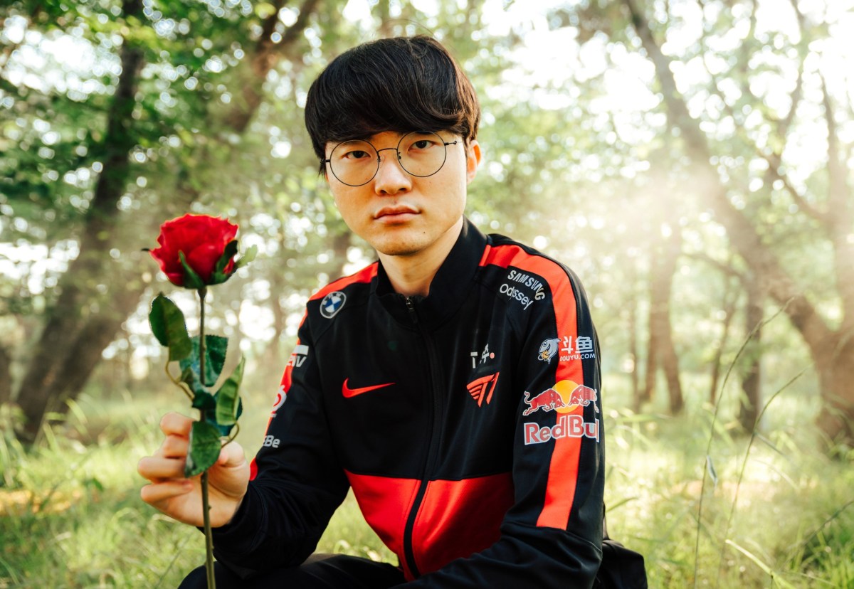 Faker elegantly kneeling in a garden holding a single rose.