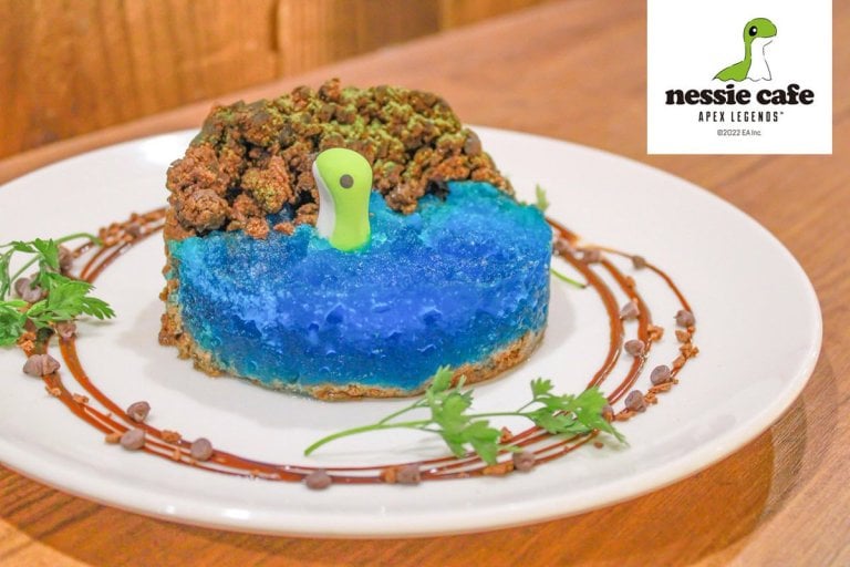 A Nessie pokes its head out of a blue cake.