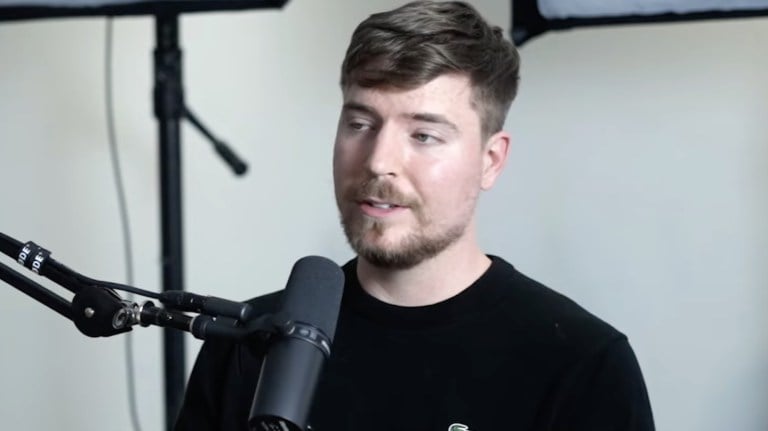 MrBeast sitting in front of a microphone while recording for a podcast.