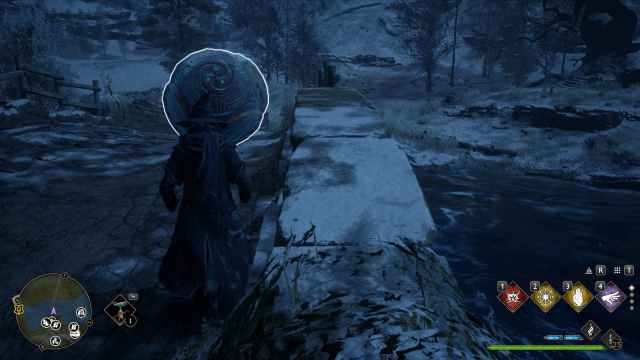 An image of a wizard close to a wall, looking at an orb in hogwarts legacy