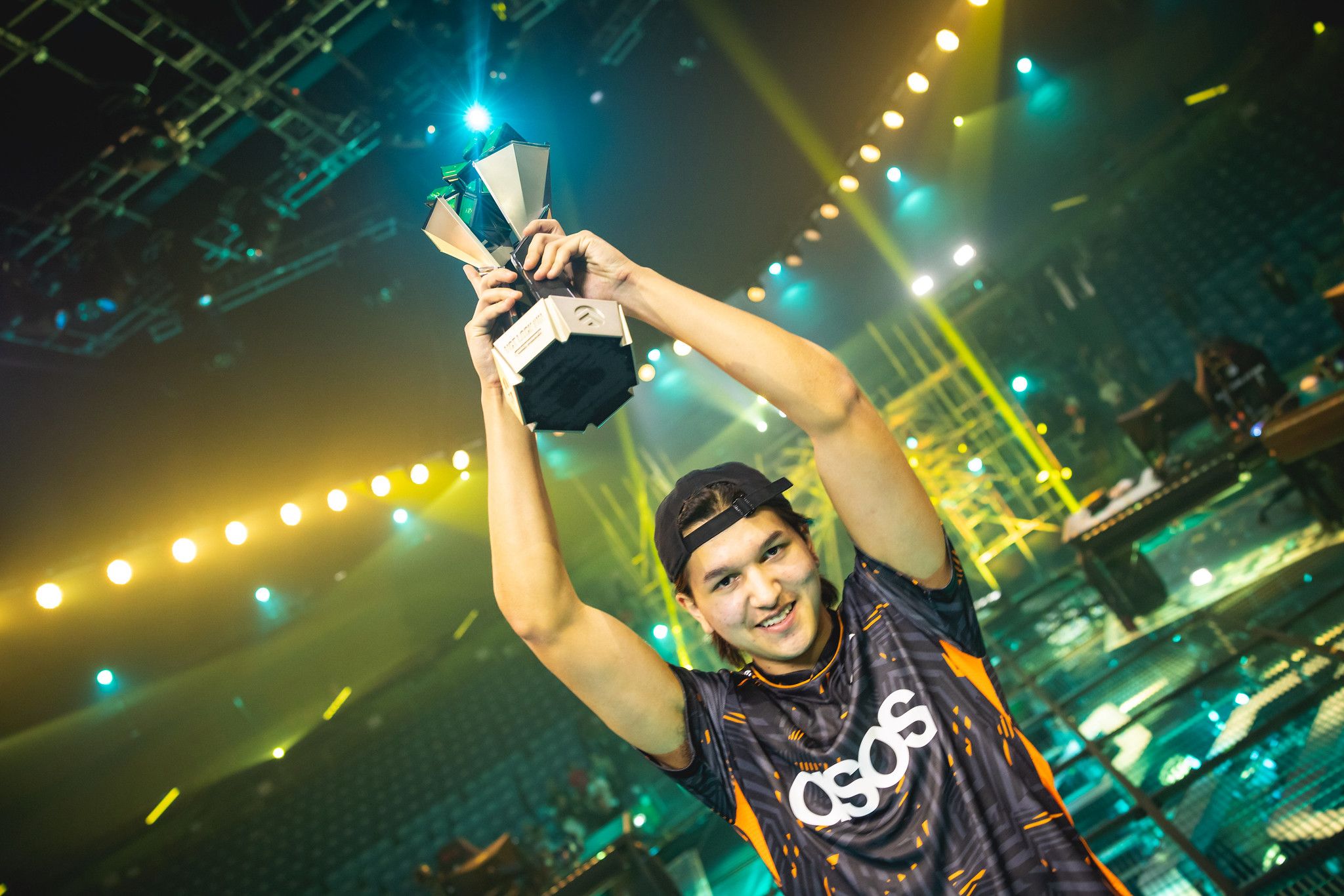 Leo holding up his trophy in an arena