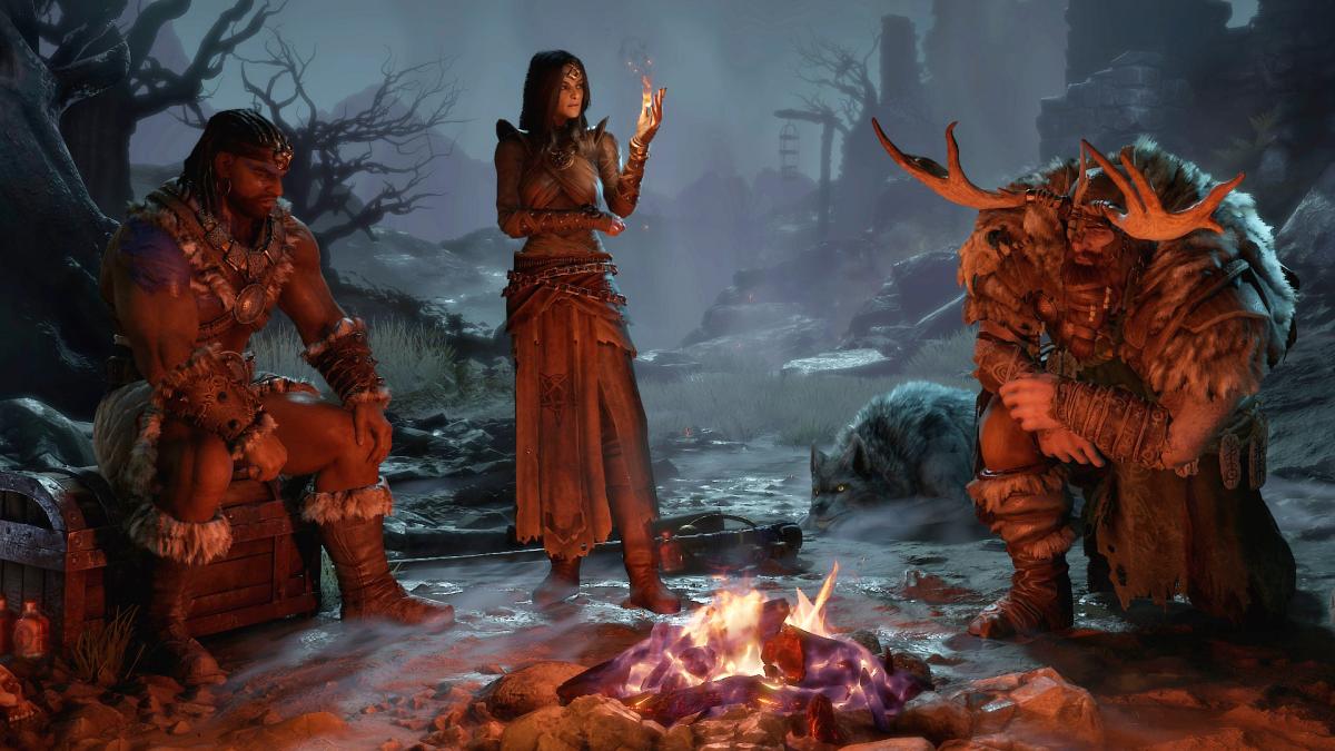 Three Diablo 4 adventurers talk around a burning fire.