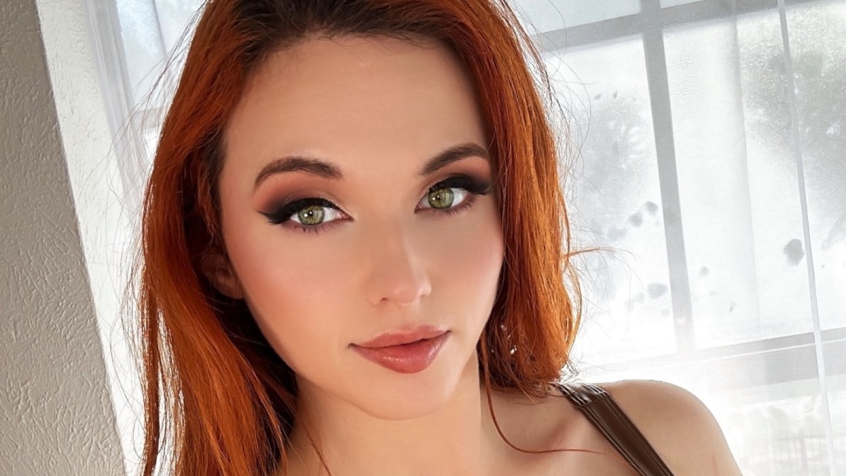 Amouranth posing for the camera in her room.