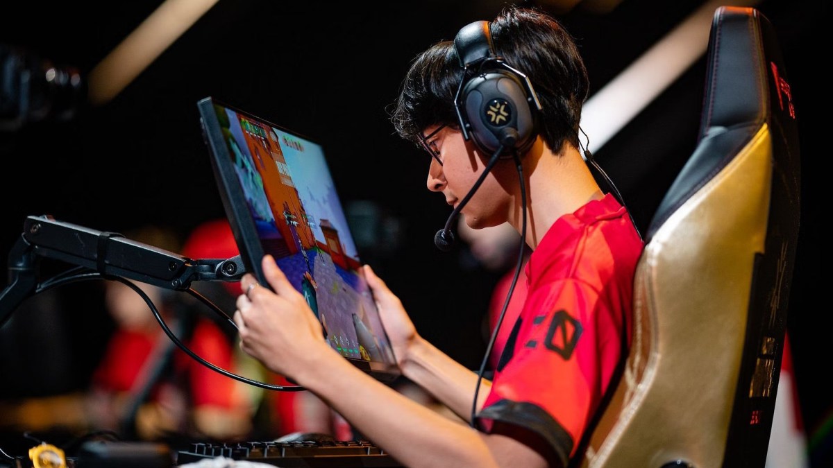 A picture of TenZ holding his monitor close to his face