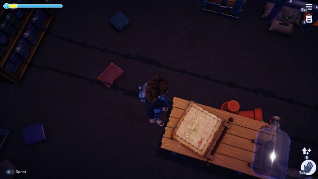 The player looking at a map on the desk in Mickey's hidden room.