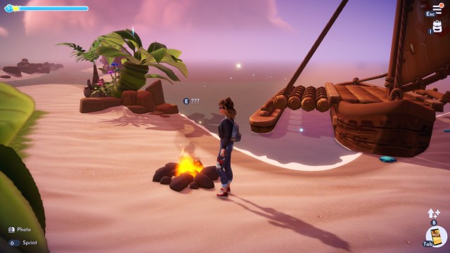 The player looking at a pebble by the fire in Moana's Realm.