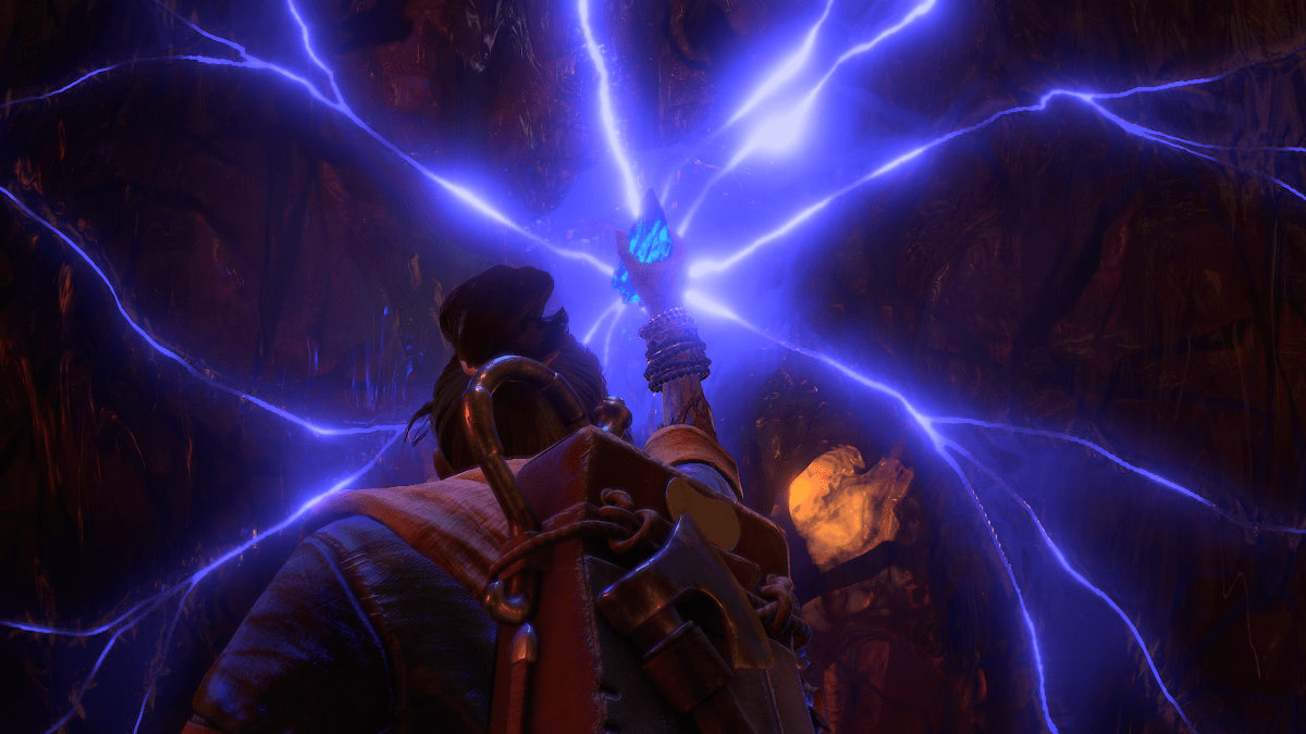 A screenshot of the Soulstone in Diablo 4 being held up in the air as it emits beams of purple light