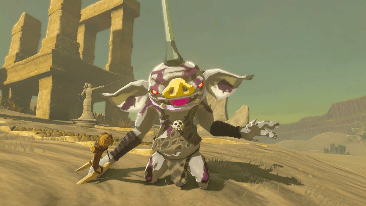 A white goblin-like creature, a Bokoblin, standing in the desert in TOTK. It's white in color with purple tribal markings, and a horn with a yellow bulb at the end, like an anglerfish. It stands upright with its mouth hanging open.