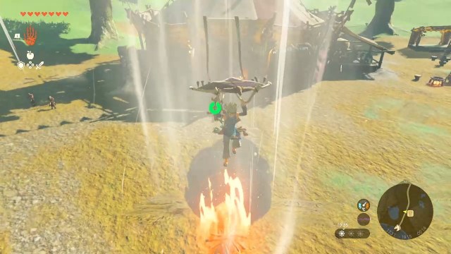 Link gliding upwards from a campfire