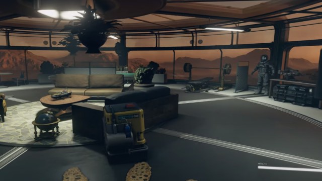 A base in Starfield, showing living quarters with a gym, sofas and a robot mop.