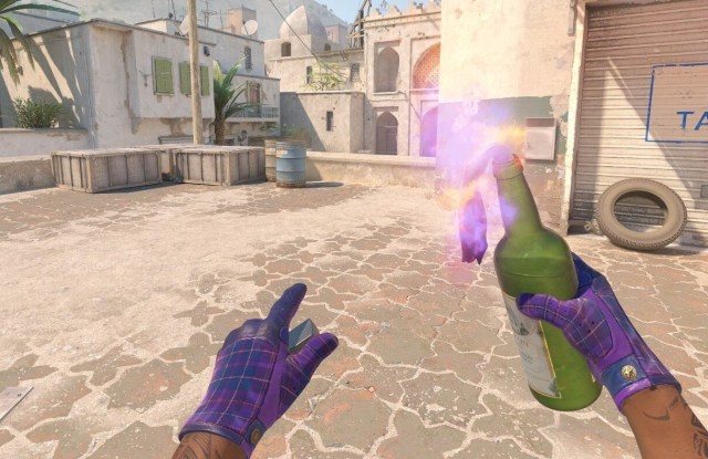 CS2 player holding Molotov grenade on Dust 2