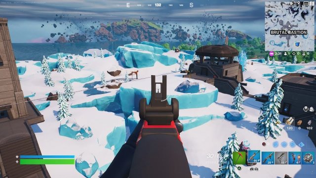 Fortnite as seen from the first-person perspective with a gun in hand.