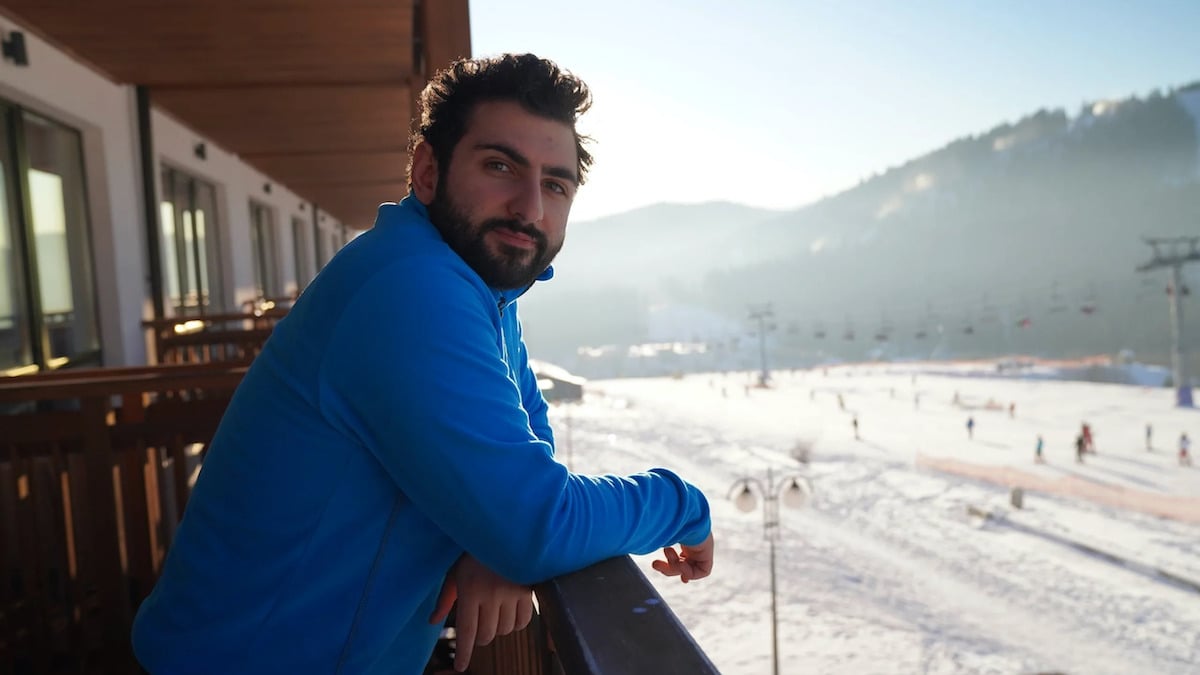 Nigma Galaxy Dota 2 player GH stands on a balcony overlooking a ski field.