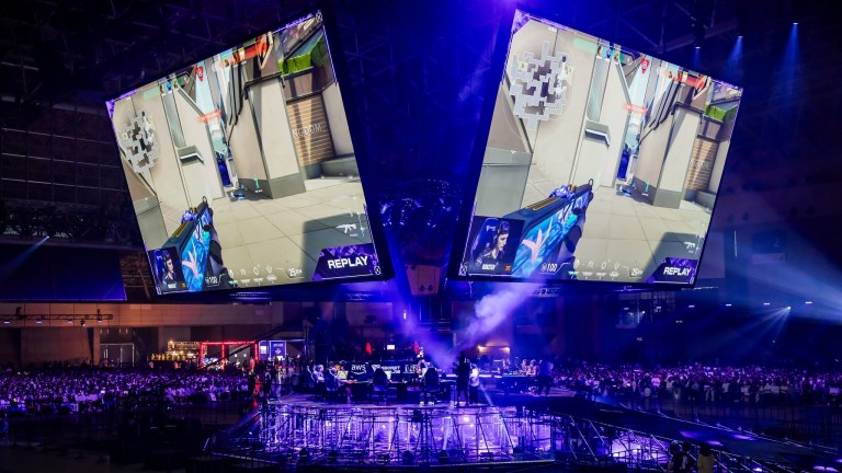 A photograph of the VCT Masters Tokyo venue. There's two large screens and the arena is lit up in purple.