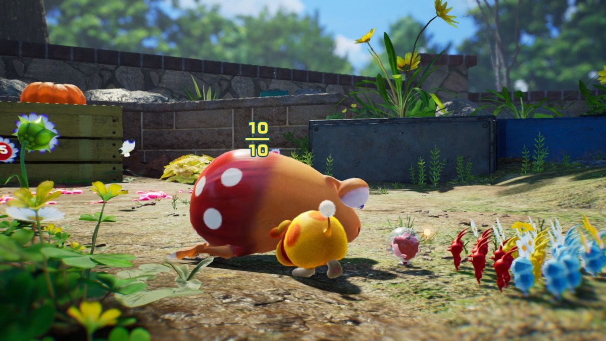 A selection of Pikmin characters navigate their way through a garden.