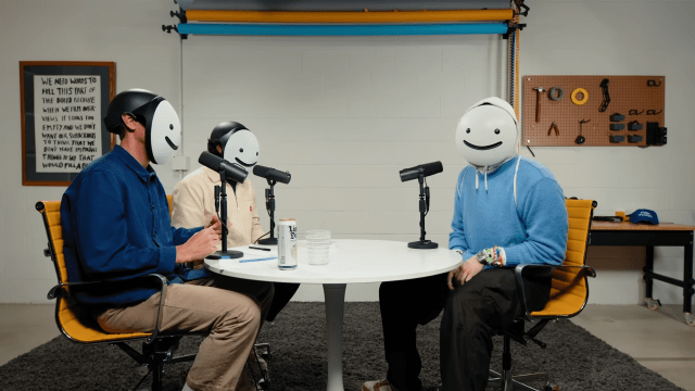 Dream, Colin, and Samir all wearing the Dream smile mask and talking during an interview. 