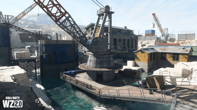 A construction crane in the middle of a quarry, with a smattering of buildings around the center in DMZ.