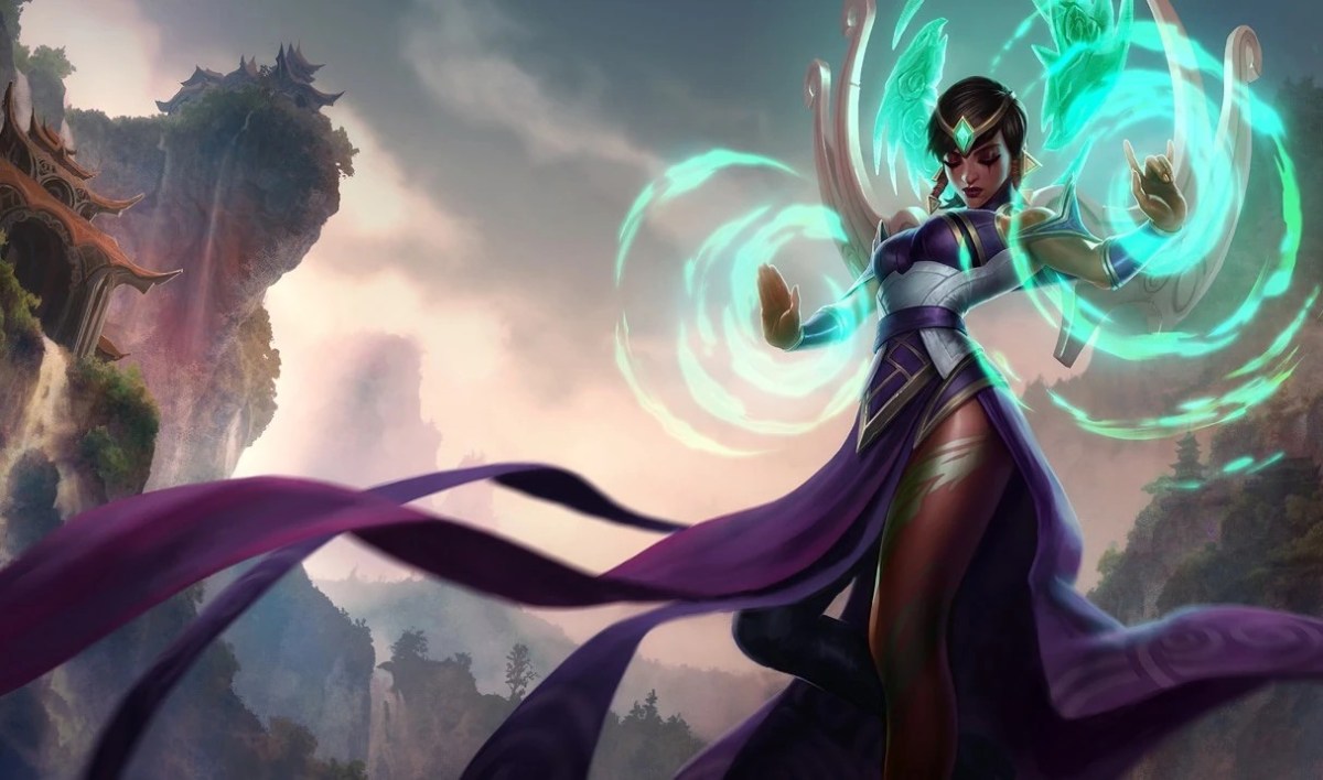 Karma, from League of Legends, poses while charging energy with a sunset in the background.