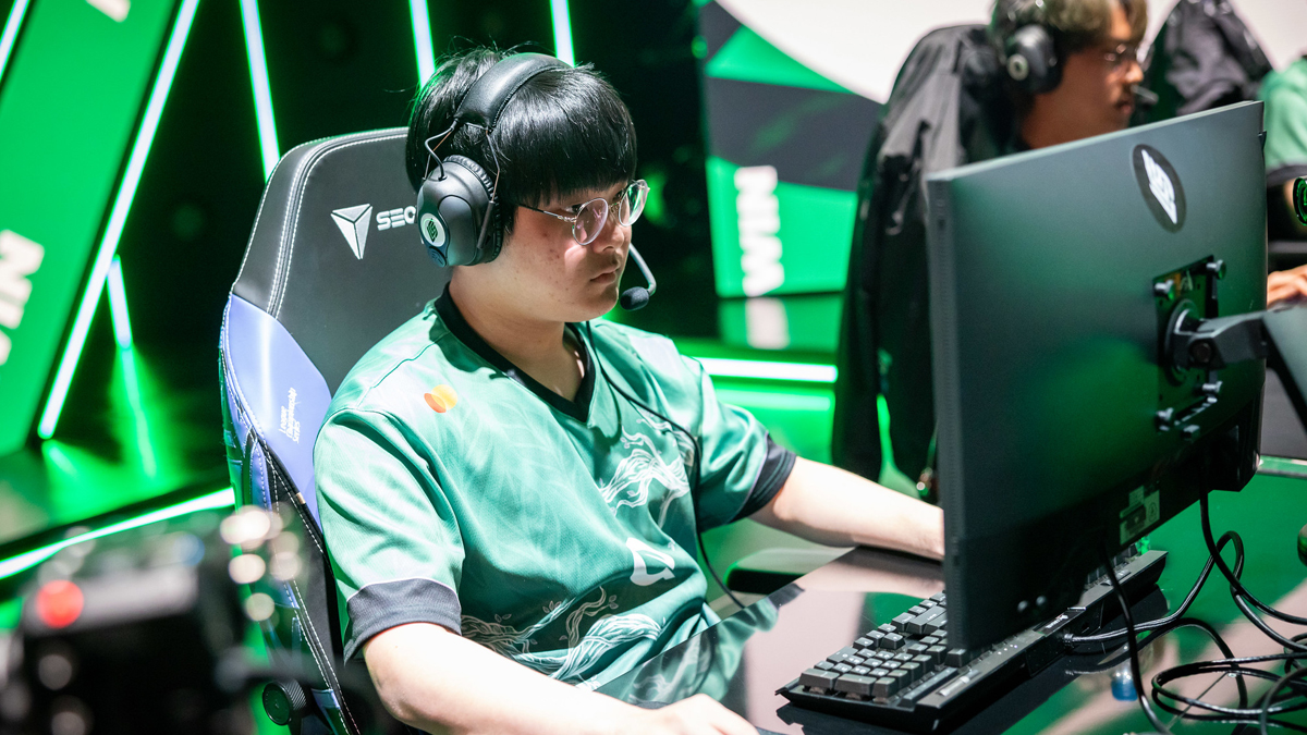 League of Legends player VicLa for FlyQuest sitting on stage and playing at the LCS 2023 Summer Split.