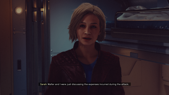 Image of a blonde woman looking forward at the player. She is wearing a leather jacket and shirt.