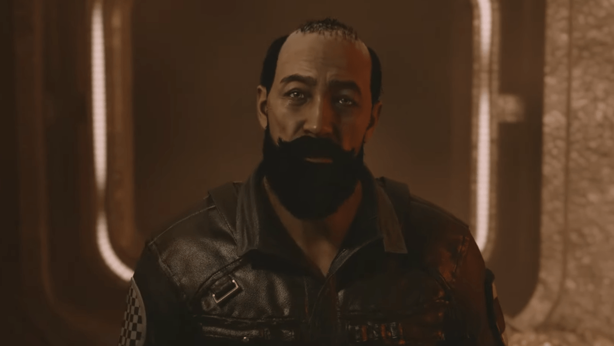 Aguerro, a bearded character from Starfield, wearing a leather jacket and staring at the player-character.