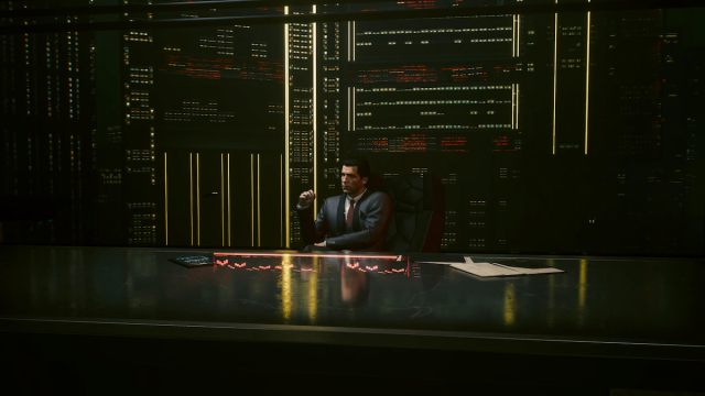 A character in a suit sits in front of a giant screen pondering in Cyberpunk 2077.