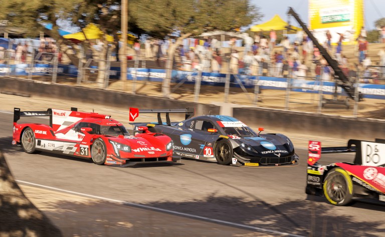 Cars racing side by side on track in Forza Motorsport.