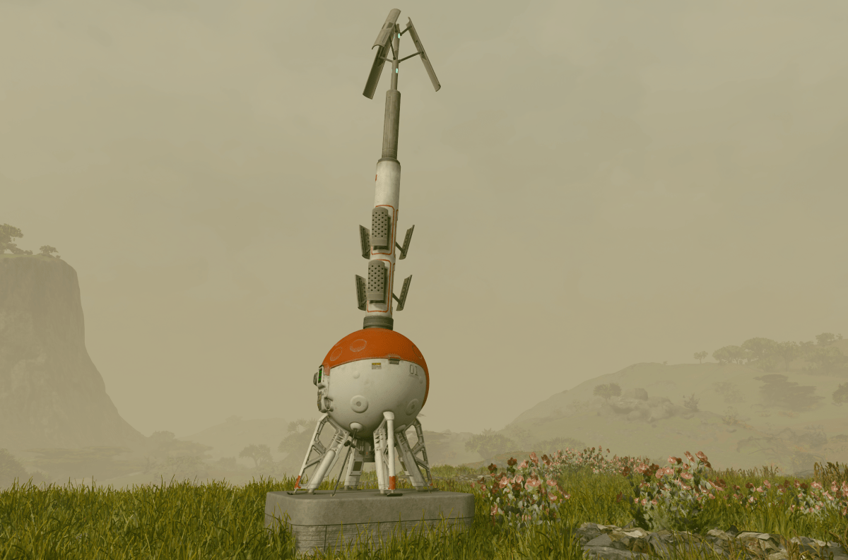 An outpost beacon, a spherical red and white orb with an antenna sticking out of it, sits in front of a foggy and hilly landscape.