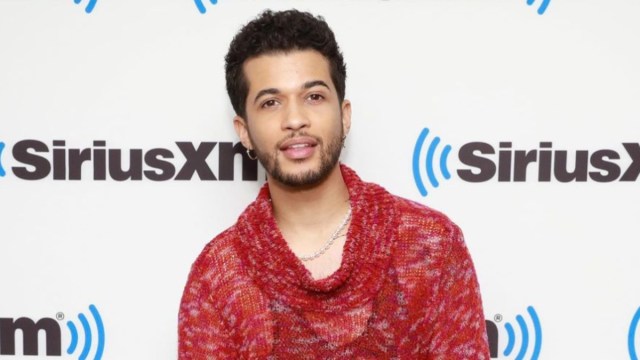 Jordan Fisher posing in front of the SiriusXM sign