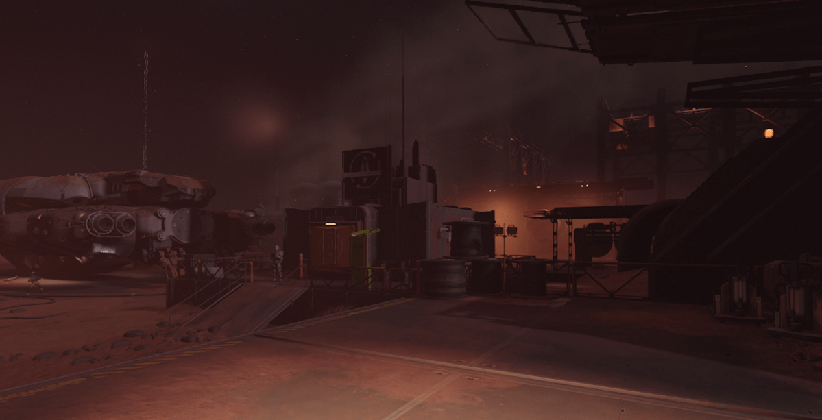 The Cydonia mining colony on Starfield. A dark and dusty area with guards standing in front of one of the gates.