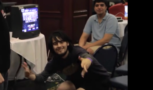 Image of Smash Bros player Mango, posing after winning a game. 