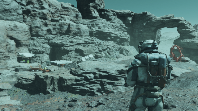 Displays the player character looking out on an outpost on the surface of a moon in Starfield.