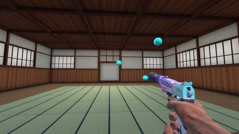 A USP shooting at blue spheres in a dojo in Aim Labs