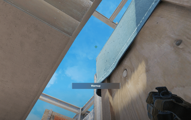 A player lines up a grenade on Vertigo in CS2.