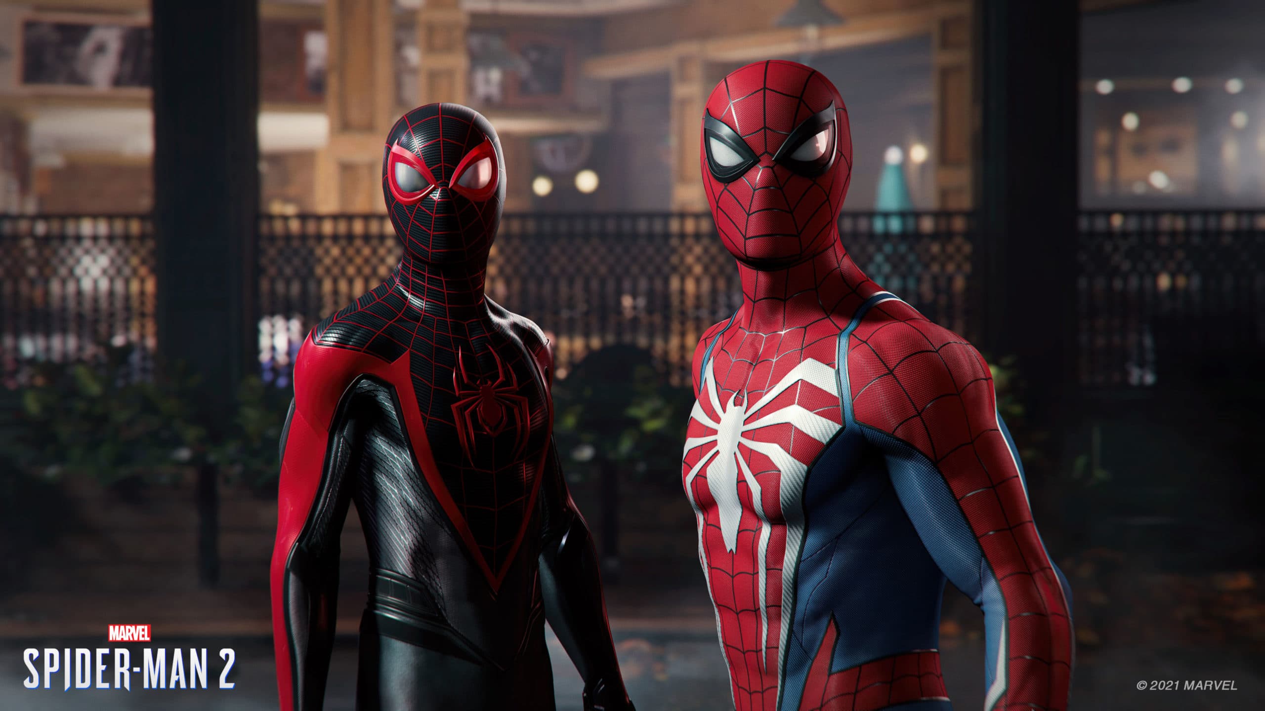 Miles Morales and Peter Parker in Spider-Man suits looking towards the camera