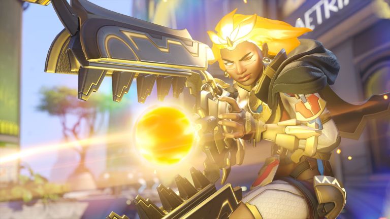 Woman with golden hair wielding a large fiery gun in OW2