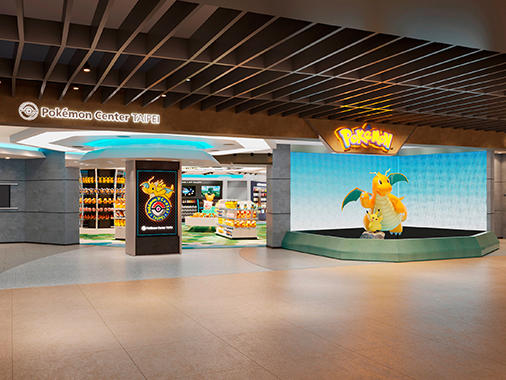 The store front to the new Pokemon Center. A Dragonite and Pikachu statue is prominently featured.