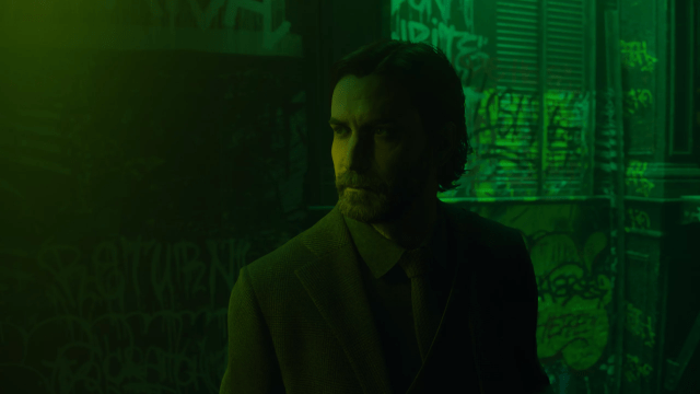 A close up of Alan Wake in green tones.