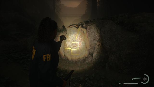 Alan Wake 2 tree with luminous 7-2 painted on it