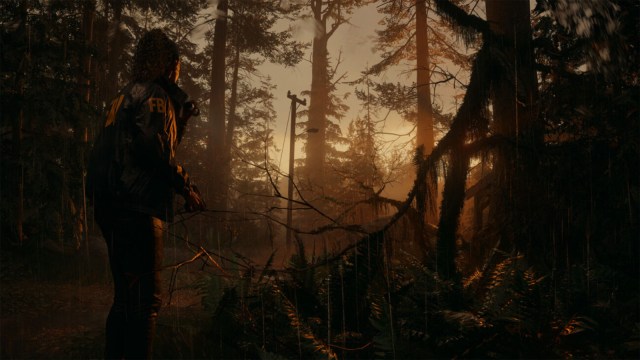 A still from Alan Wake 2 showing a character in a forest surrounded by trees.