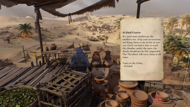 Image of a man in a white robe reading a letter in the desert.