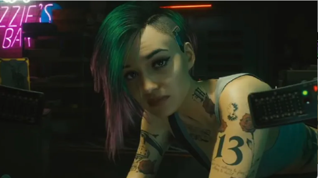 Judy from Cyberpunk 2077 stares at V (the camera).