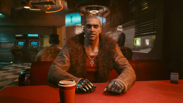 River ward sits at table in Cyberpunk 2077. 