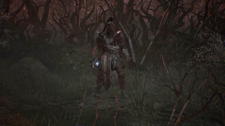 A character in Lords of the Fallen standing in a barren field.